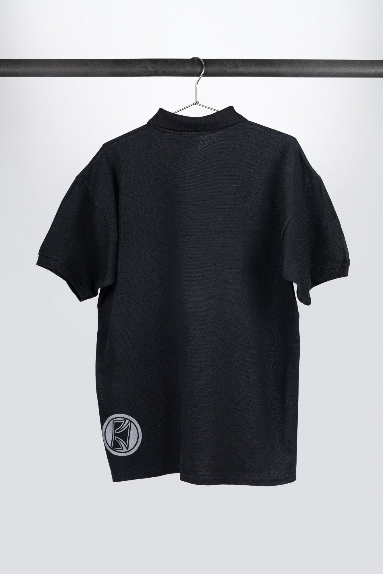 Tama polo in black with logo on left chest
